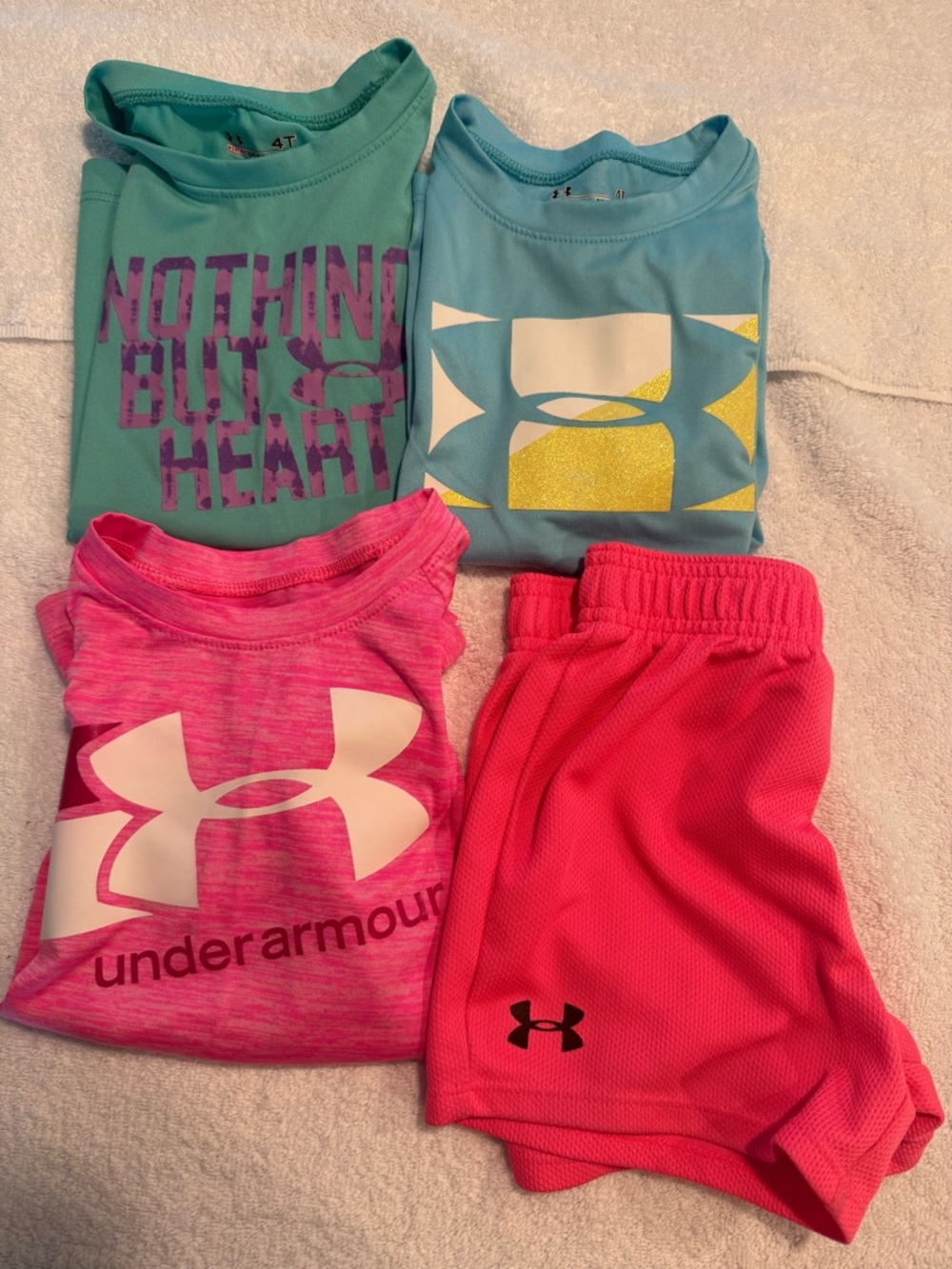 4 pieces of girls Under Armour Tee shirts  & Shorts.  Girl’s size 4T & 5.